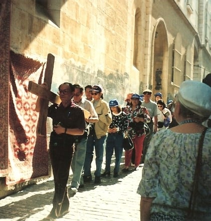 Tourists can rent a cross and carry it through Via Dolorosa street