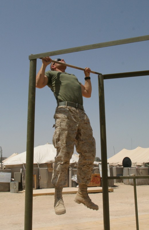 A Marine at the apex position of a pullup.