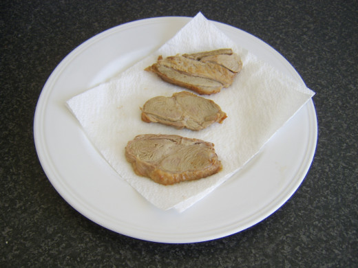 Draining refried turkey slices on kitchen paper