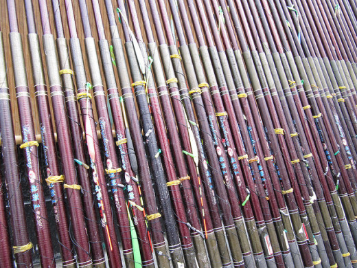 Fishing poles stacked up at the tackle store ready for purchase.