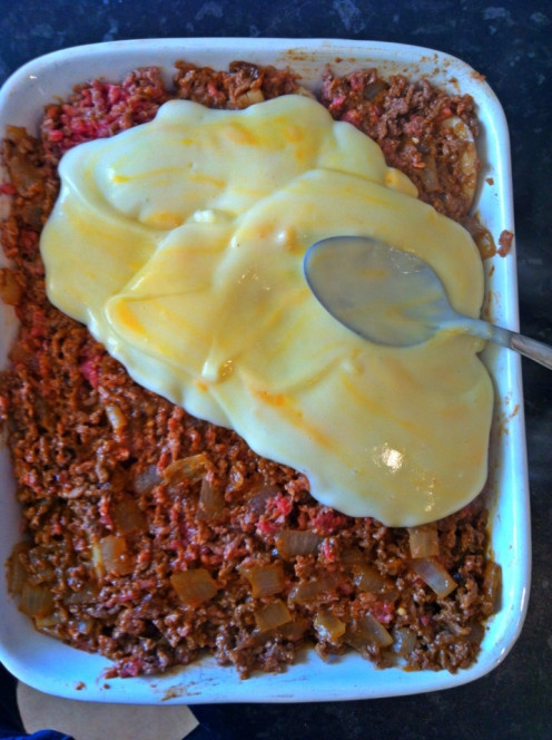 Spread over with mince and cheese sauce