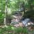 Water winding its way through the woods and creating little water falls. Water winding its way through the woods and creating little water falls.