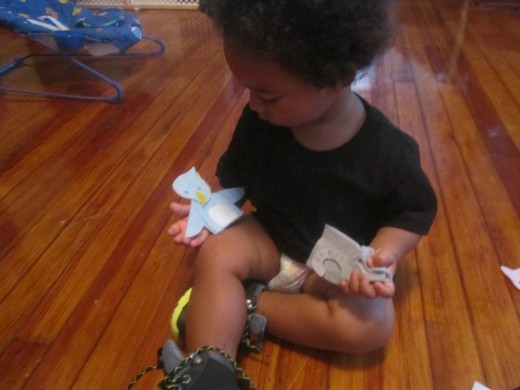 Juju kept pulling them off my fingers and would sometimes try to put them on his own, but mostly enjoyed cradling them like babies.  (If you're wondering where his pants went, your guess is as good as mine.)