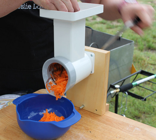 Hand crank Family Grain Mill system with optional food chopper.