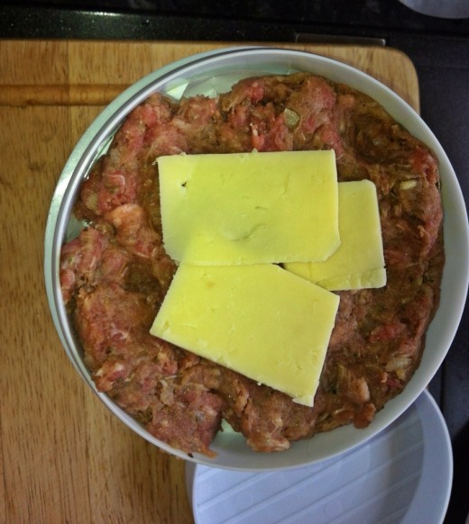 This is how I put the cheese in the burger press, half fill with cheese, and then top with mince