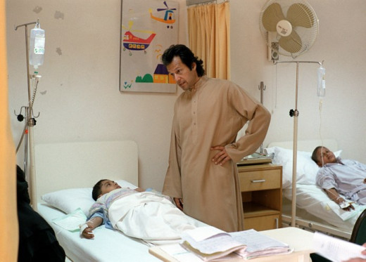 Imran khan the founder of SKM Hospital busy with  patient.