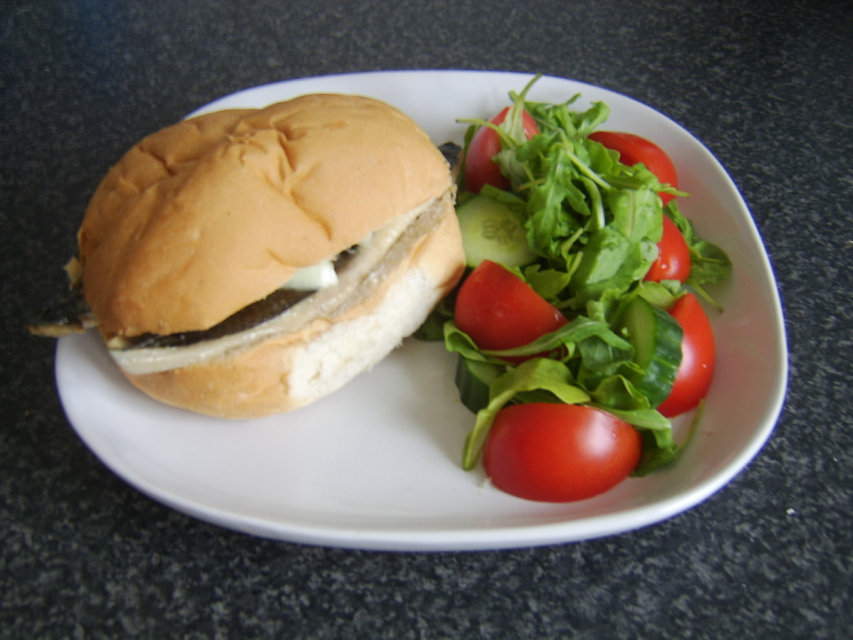 Ready to eat herring shish kebabs on bread roll with salad