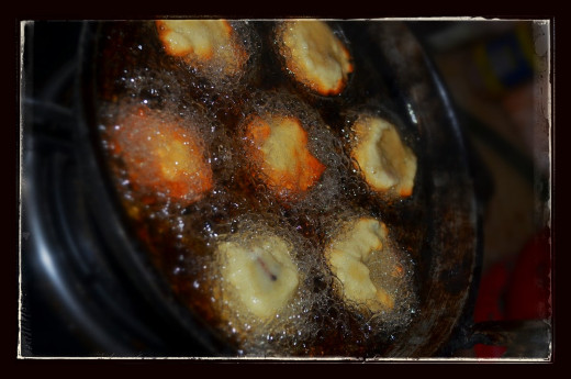 Add the unniyappam dough to the unniyappam mould, where oil is hot enough; only fill half of the mould and the unniyappam will become larger while it is cooked. now cook it by turning it upside down.