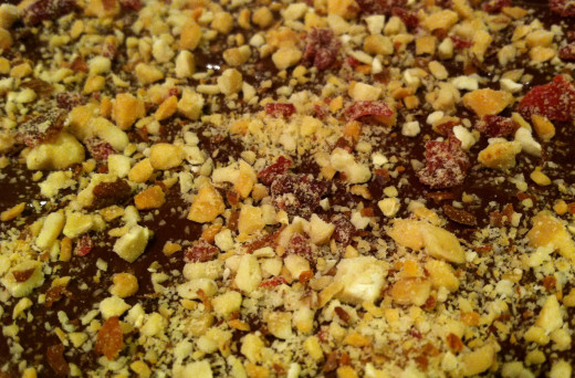 Nuts and cranberries will be thicker the first time you sprinkle them on the chocolate. The next and final time you will only want to sprinkle a small amount to go on the very top.