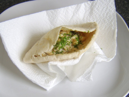 Pitta bread pocket filled with scrambled egg, porcini mushrooms and Worcester sauce, garnished with chopped chives