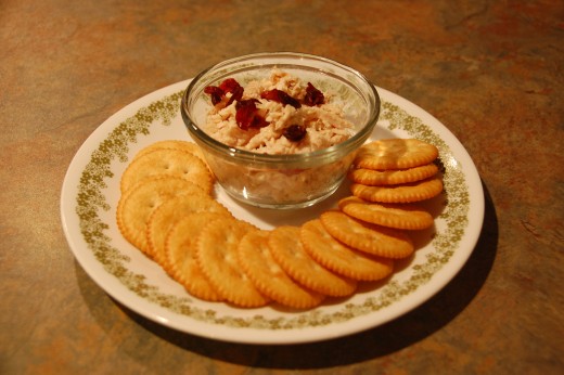 Easy chicken salad, topped with dried cranberries and served on crackers, yumm!