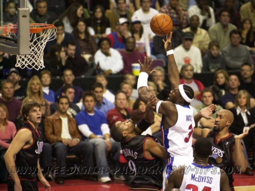 Ben Wallace formerly of the Detroit Pistons takes a shot over some Philadelphia 76ers during a NBA basketball game in Detroit Michigan. This photo was taken with a Nikon D1 back in November 6, 2004. It was a great camera back in 2000, with 4.5 frames