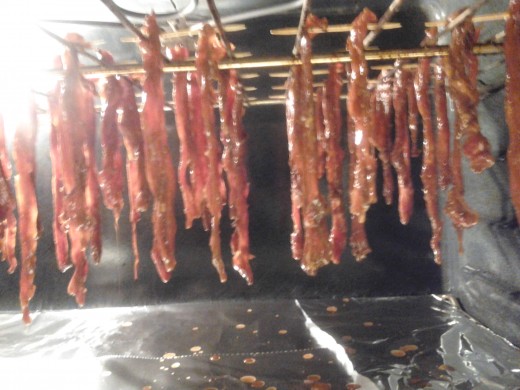 Flank steak strips hanging in the oven, ready for their 8 hour "dehydration".