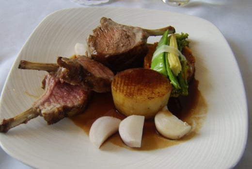 Rack of lamb with fondant potato and assorted vegetables