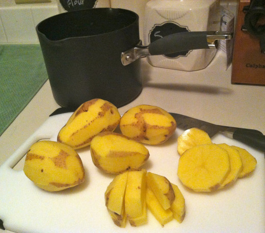 Start off peeling and chopping your potatoes. 