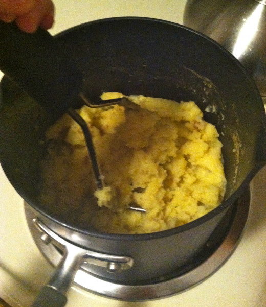 After you drain the water, begin mashing with a potato masher