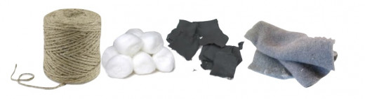 These items make great fire starting tinder. They are readily available, light weight and cheap. (Left to right) jute twine, petroleum jelly impregnated cotton balls, char cloth and drier lint.