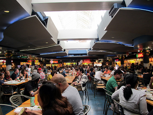 Sit down in a local coffee shop, restaurant or any public area and observe how the locals act and talk