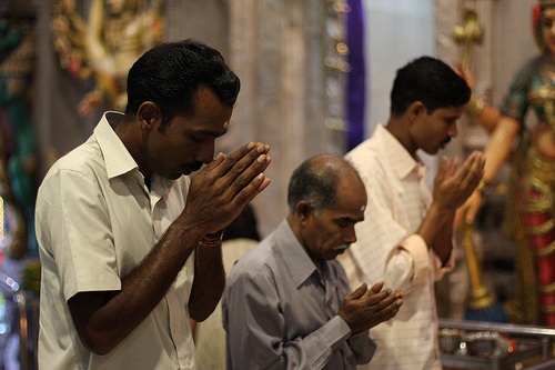 Singaporean/Malaysian Indians offering prayers in a Hindu temple