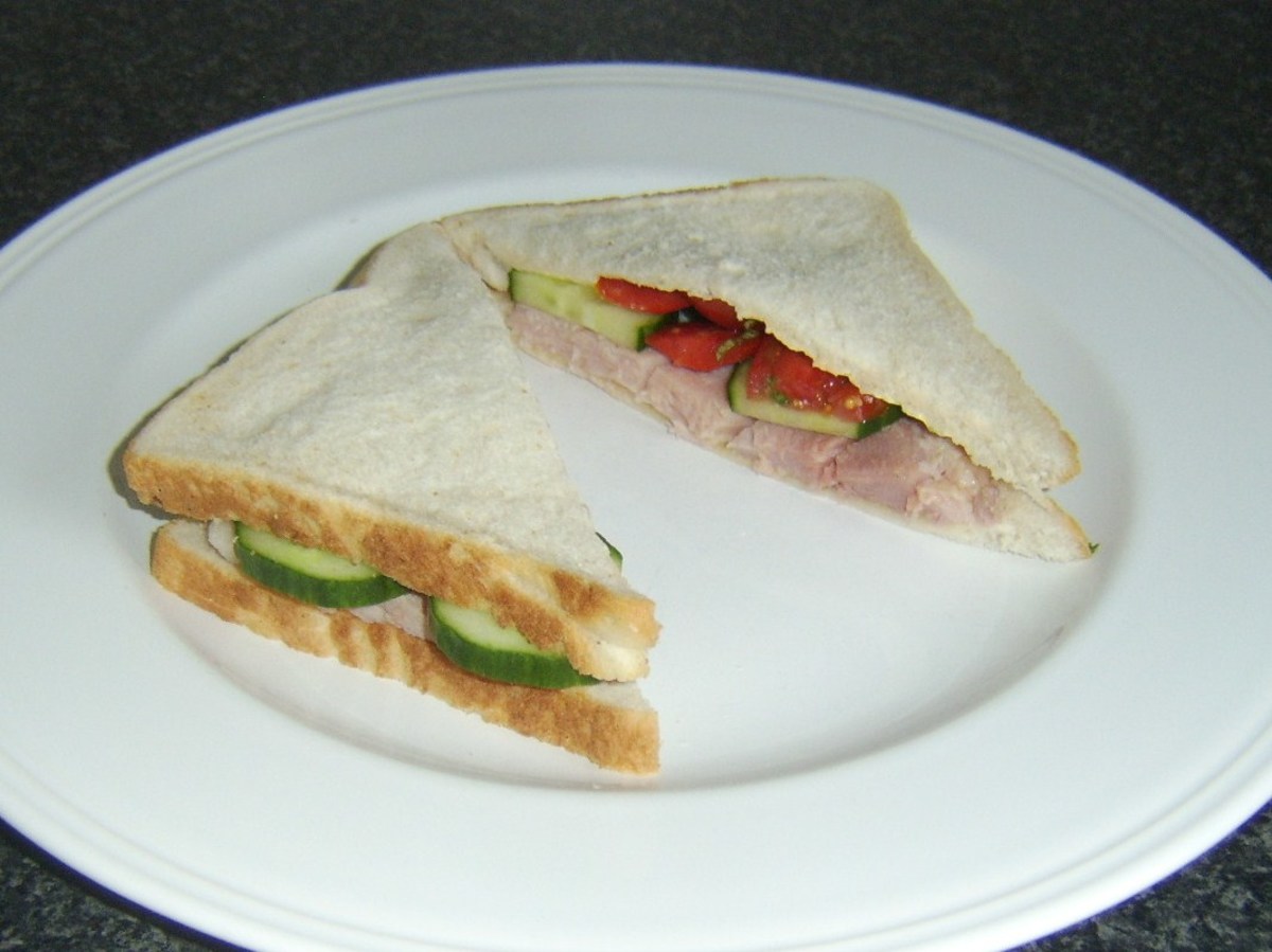 Simple ham, cucumber and tomato sandwich is served