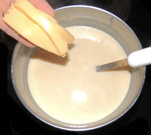 add cheese strips in increments, stirring frequently
