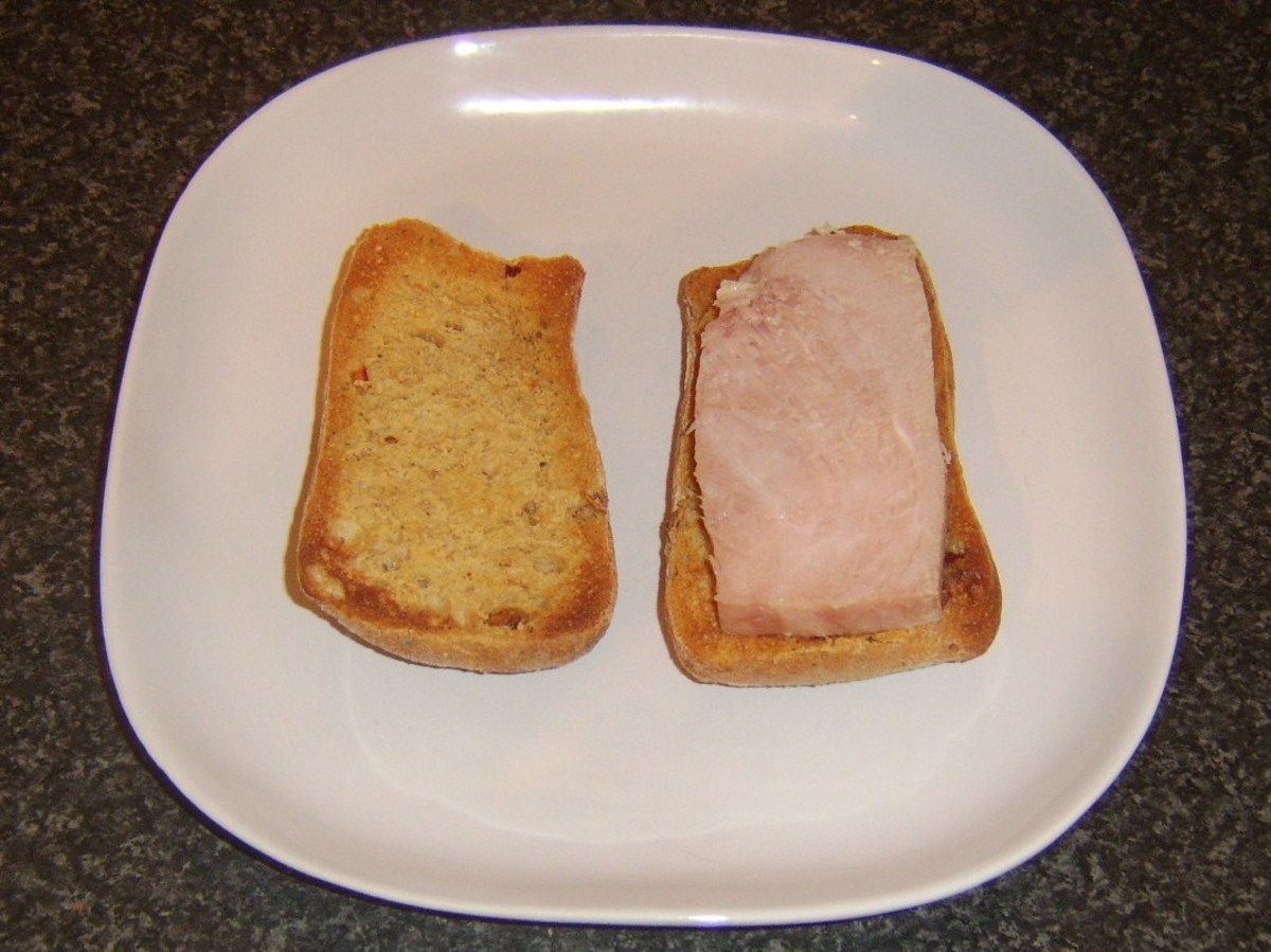Slice of ham is laid on bottom half of ciabatta