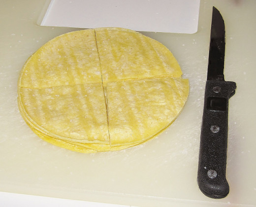 Cut your tortillas, flour or corn, into four pieces.