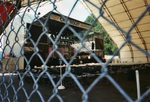 We walked to the amphitheater and took this picture through the fence of the crew testing the video screens. This is about how far back our seats were too.