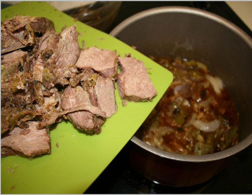 Meat sliced and being slid into the final Hatch Green Chile Broth.