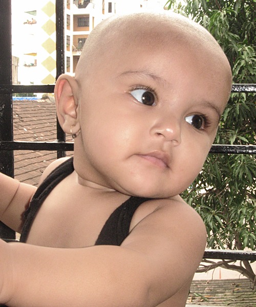 A bald kid in window
