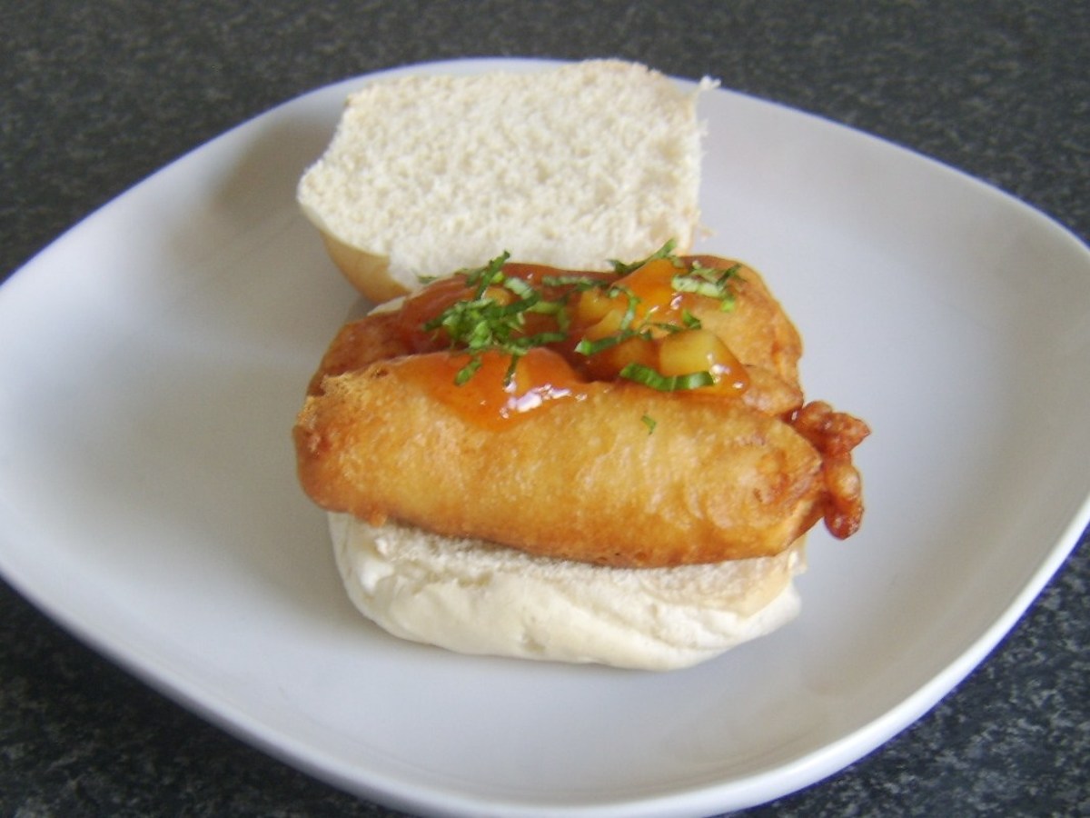 Succulent chicken breast strips deep fried in apple cider batter are served with mango chutney on a bread roll