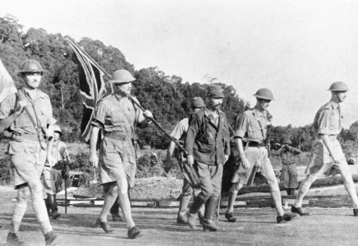 Lieutenant-General Arthur Percival (centre, holding the Union Jack) and British troops making their way to surrender to the Japanese forces in Singapore