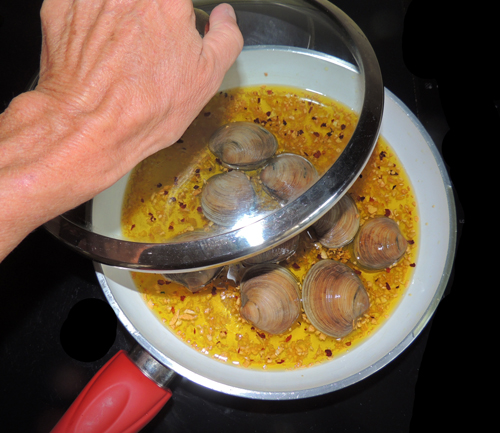 cover. Shaking vigorously intermittently, cook until all clams open--about 5-8 minutes