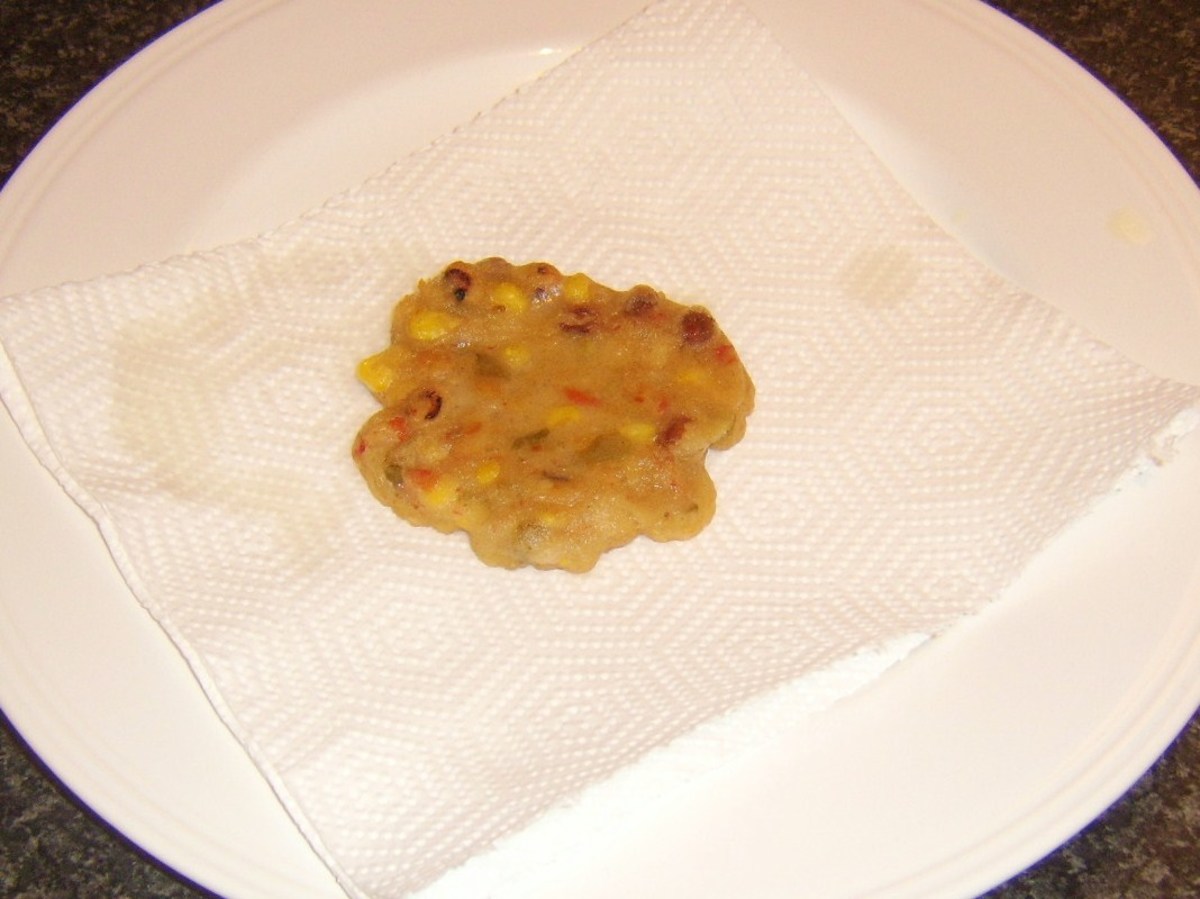 Bean fritter is drained on kitchen paper