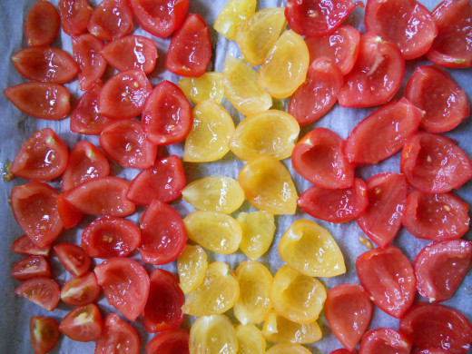 Larger red and yellow tomatoes, quartered and deseeded, ready for drying