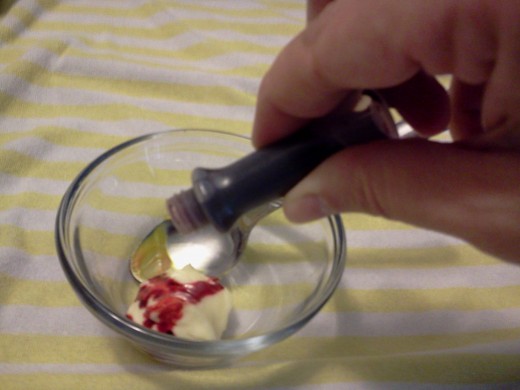 Adding food color to one of the mayonnaise bowls.