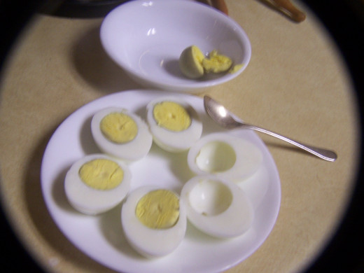 Scoop the yokes into a bowl ready for adding Mayonaise.
