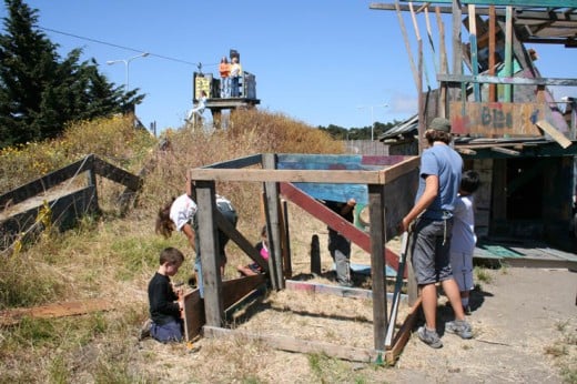 Kid-built fort at the Berkely Adventure Playground; notice the zip-line in the top left of photo.