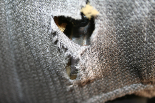 A hole in the driver's seat of the van was allowing a metal mechanism to poke through and puncture holes in my pants when I would sit down to drive.
