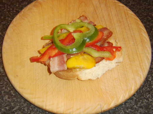 Bell pepper slices are laid on bacon