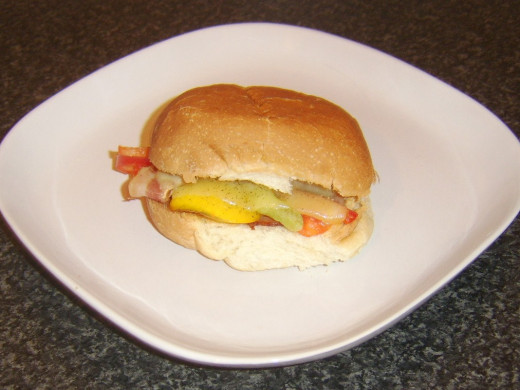 Top is placed on cheesy bacon and bell pepper roll to serve