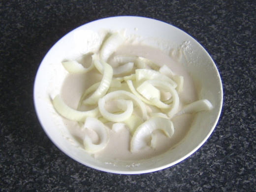 Onion slices are dipped in batter
