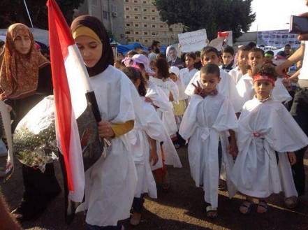Egyptian Children dressed in ‘white death shrouds’ at a pro-Morsi demonstration