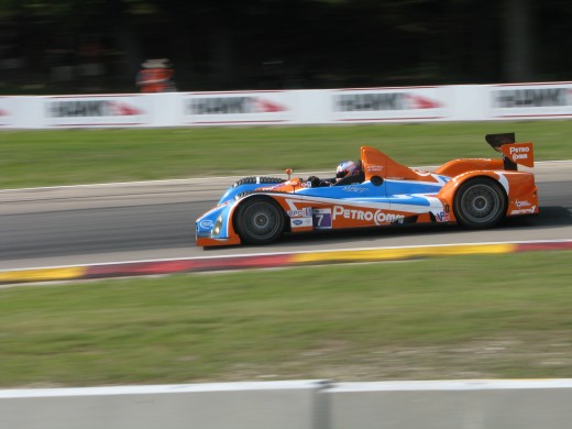 LMPC car at Road America. Notice how the trees and signs are blurred, emphasizing the motion of the race car. 