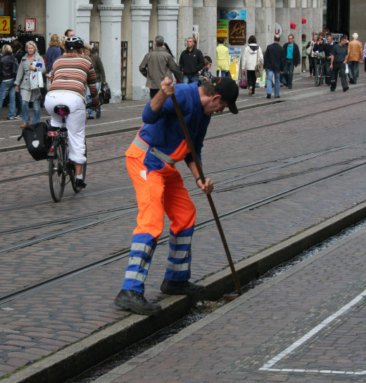 Worker cleaning drainage ditch in Freiburg, Germany