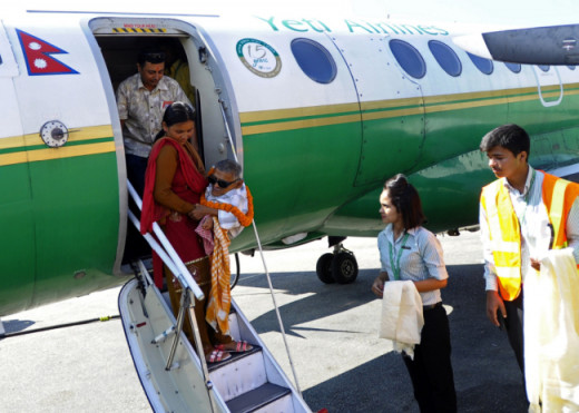 Master Nau being carried out of an airplane.