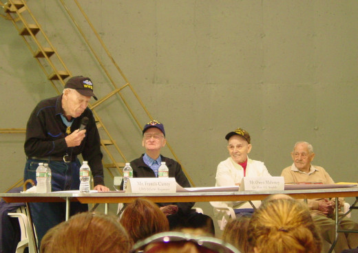 Frank Currey speaks of his exploits at the Battle of the Bulge which won him the Medal of Honor while Owen Mahoney, Robert Cotnoir and Joseph Gosselin look on
