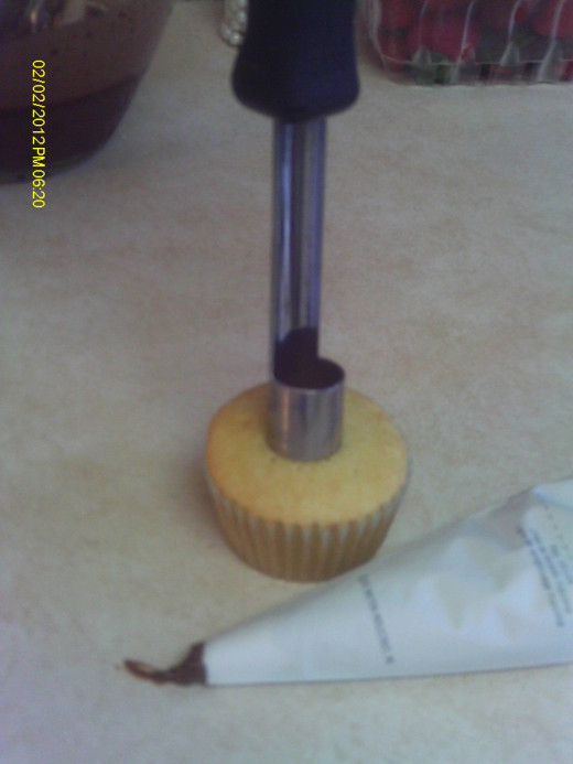 Use an apple corer to remove the center of the cupcake.