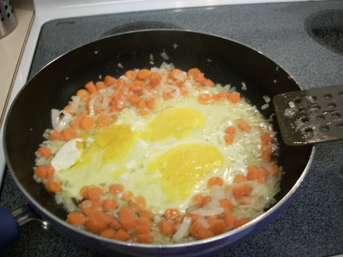 Make a well in the middle of the pan and add 1 Tablespoon Coconut Oil, then crack the three eggs in the middle and scramble.