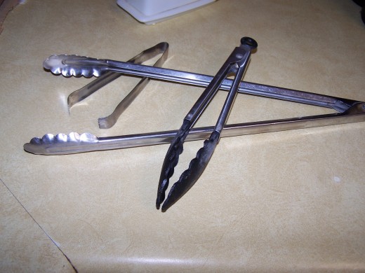 Tongs used to coat the pasta with a light coat of sauce. Also for serving the pasta.